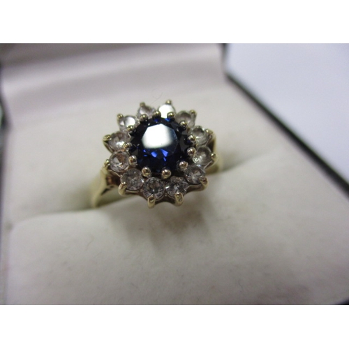 18 - A 9ct yellow gold daisy ring with a central rich blue sapphire, approx. ring size M approx. weight 2... 