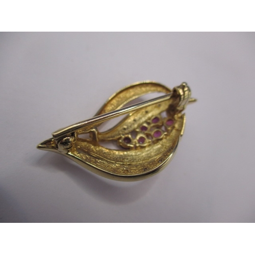 76 - A 9ct gold diamond and ruby brooch, approx. weight 3.9g in good pre-owned condition