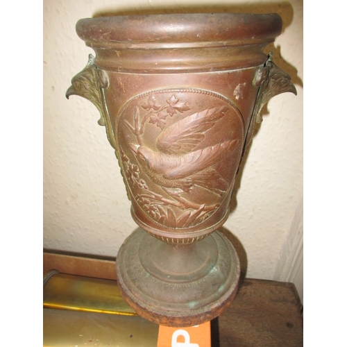 21 - A parcel of metalwares, to include WWI shell cases, cast iron wall sconces and vases, all in used co... 