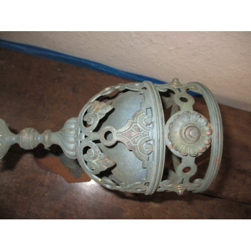 21 - A parcel of metalwares, to include WWI shell cases, cast iron wall sconces and vases, all in used co... 