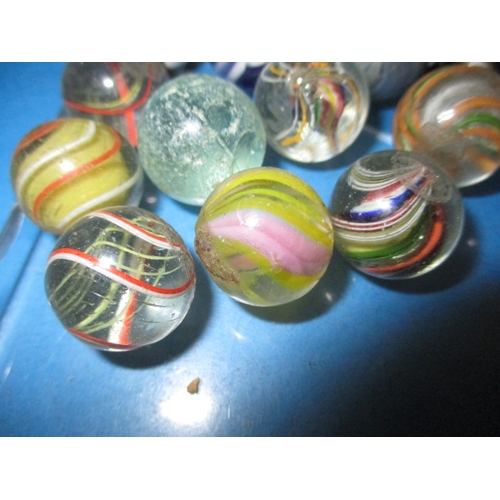 35 - A parcel of antique and later glass marbles, to include hand blown examples, all in used condition w... 