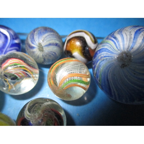 35 - A parcel of antique and later glass marbles, to include hand blown examples, all in used condition w... 