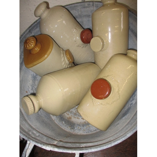 43 - Two vintage galvanised bath tubs and a quantity of stoneware water bottles and jugs, all in used con... 