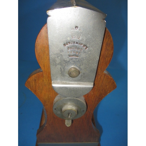 71 - A vintage Betjemanne patent 3 bottle tantalus, opens but no key and having one small flake chip to o... 