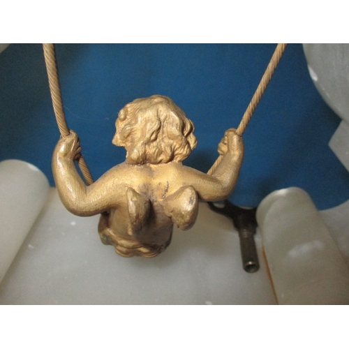 74 - An antique alabaster clock with swinging cherub pendulum, under original glass dome, dome in good co... 