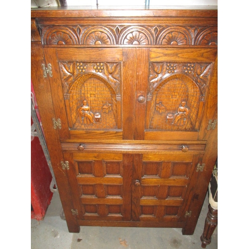 102 - A vintage oak cocktail cabinet, with glass racks, bottle cupboard and mixing slide, approx. size: H ... 