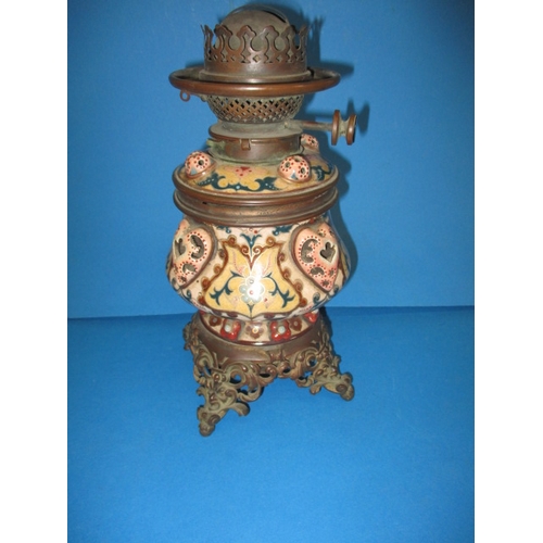 128 - A late 19th century oil lamp body with Duplex twin burner, having a floral design ceramic and brass ... 