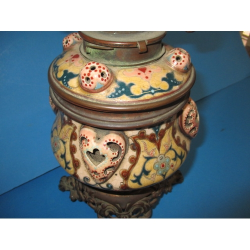 128 - A late 19th century oil lamp body with Duplex twin burner, having a floral design ceramic and brass ... 