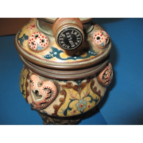 128 - A late 19th century oil lamp body with Duplex twin burner, having a floral design ceramic and brass ... 