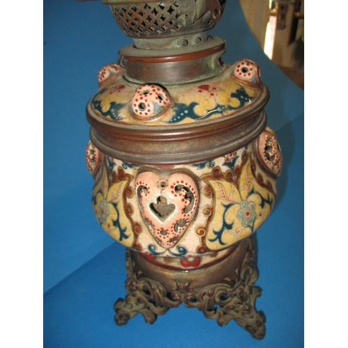 128 - A late 19th century oil lamp body with Duplex twin burner, having a floral design ceramic and brass ... 