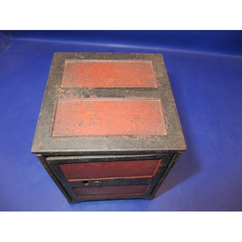 133 - A vintage  steel money box in the form of a safe, with key and use-related marks