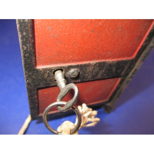 133 - A vintage  steel money box in the form of a safe, with key and use-related marks