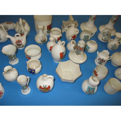 136 - A very large quantity of crested china, to include examples by Goss and Arcadian, all with no observ... 