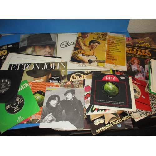 138 - A large quantity of 12 & 7 inch vinyl records, to include examples by the Beatles and Elvis, all in ... 