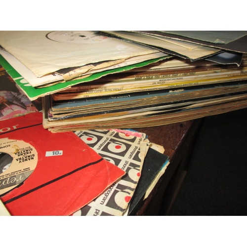 138 - A large quantity of 12 & 7 inch vinyl records, to include examples by the Beatles and Elvis, all in ... 