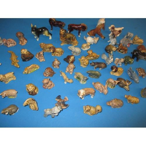 139 - A large collection of vintage miniature ceramic animals, most by Wade, all with no observed damage