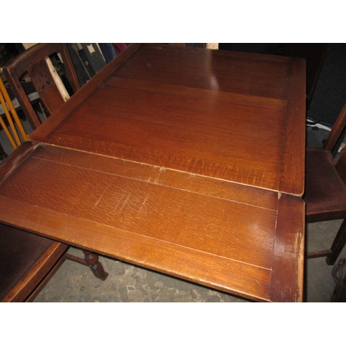 152 - A mid 20th Century oak drawer leaf table and 4 chairs. Size closed approximately 90 x 90cm, both lea... 