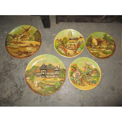 156 - A parcel of 1950’s plaster wall plaques, with country scenes, some minor damages. Approximate diamet... 