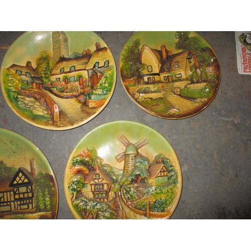 156 - A parcel of 1950’s plaster wall plaques, with country scenes, some minor damages. Approximate diamet... 