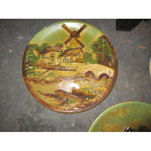 156 - A parcel of 1950’s plaster wall plaques, with country scenes, some minor damages. Approximate diamet... 