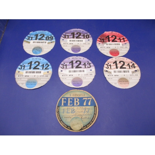 Seven vintage vehicle tax discs, all in used condition