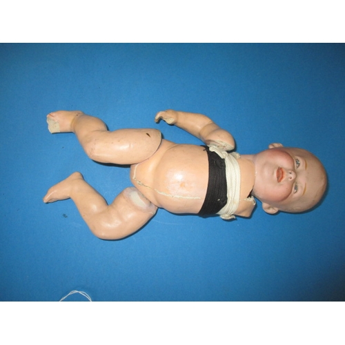 165 - A vintage German bisque head doll, damaged body and one arm missing, but head looks ok, approx. leng... 