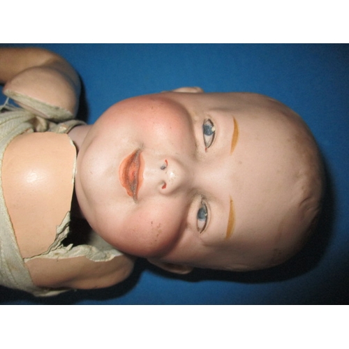 165 - A vintage German bisque head doll, damaged body and one arm missing, but head looks ok, approx. leng... 