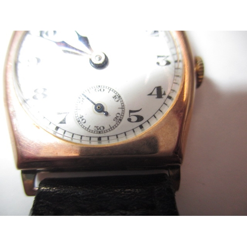 131 - A vintage 9ct gold cased wrist watch with leather strap, in working order with minor age-related mar... 