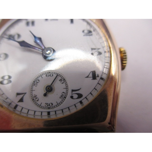 131 - A vintage 9ct gold cased wrist watch with leather strap, in working order with minor age-related mar... 