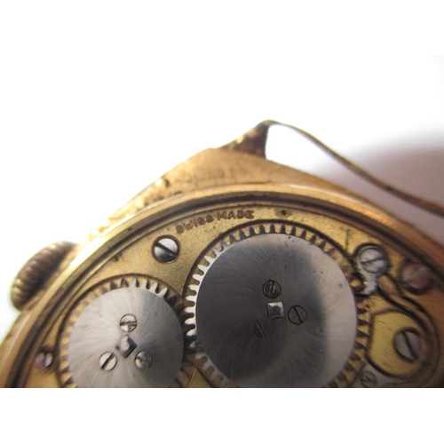 134 - A 1930s 18ct gold cased wrist watch, in well used condition, still runs when wound, no strap and gen... 