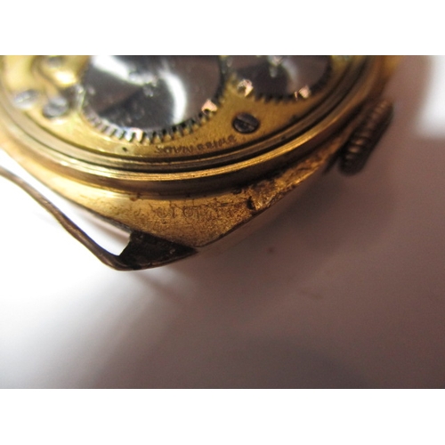 134 - A 1930s 18ct gold cased wrist watch, in well used condition, still runs when wound, no strap and gen... 