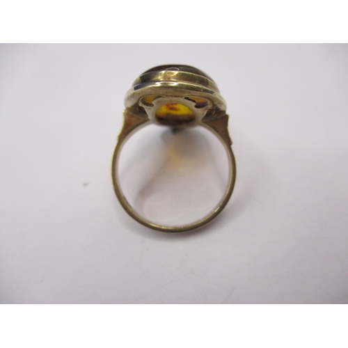 17 - A 1930s gold ring with a single oval cabochon amber panel, marked 333, approx. ring size ‘O’, approx... 