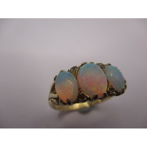 26 - An 18ct yellow gold ring with 3 natural cabochon opals, approx. ring size ‘O’, approx. weight 4.5g, ... 