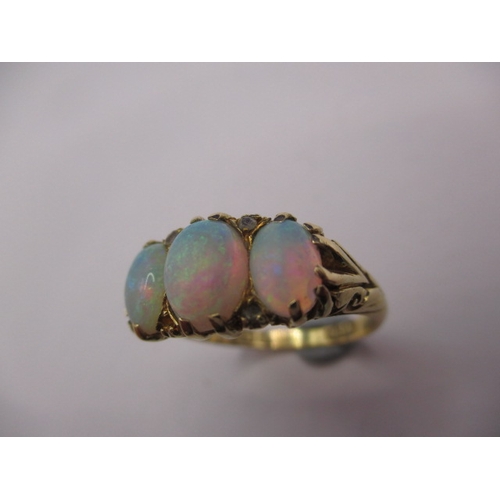 26 - An 18ct yellow gold ring with 3 natural cabochon opals, approx. ring size ‘O’, approx. weight 4.5g, ... 