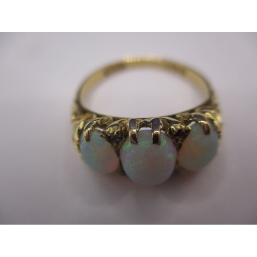 26 - An 18ct yellow gold ring with 3 natural cabochon opals, approx. ring size ‘O’, approx. weight 4.5g, ... 