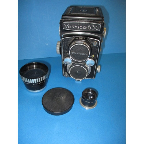 354 - A mid 20th century Yashica 635 camera, with additional telephoto lens, functions and has general use... 