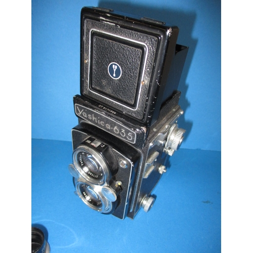 354 - A mid 20th century Yashica 635 camera, with additional telephoto lens, functions and has general use... 