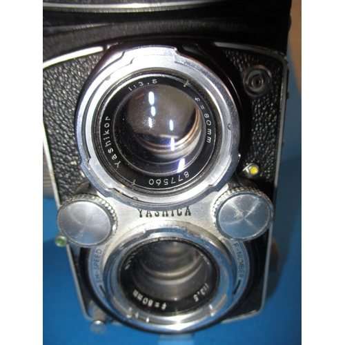 354 - A mid 20th century Yashica 635 camera, with additional telephoto lens, functions and has general use... 