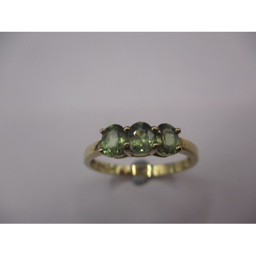 30 - A 9ct yellow gold dress ring with 3 Madagascan green garnets, approx. ring size ‘N’, approx. weight ... 