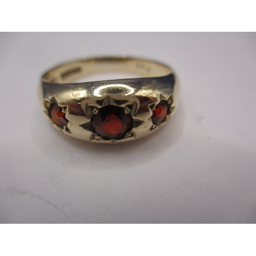 35 - A vintage yellow gold dress ring with 3 red stones, approx. ring size ‘Q+’, approx. weight 3.3g, in ... 