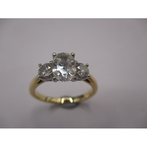 36 - An 18ct yellow gold and diamond ring , the central oval shaped stone is brilliant cut and approx. 0.... 