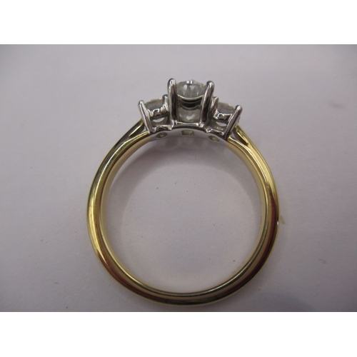 36 - An 18ct yellow gold and diamond ring , the central oval shaped stone is brilliant cut and approx. 0.... 