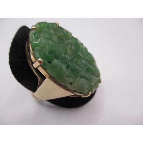 38 - A 9ct yellow gold ring with lotus blossom carved jade panel 20x30mm, approx. ring size ‘O’ approx. w... 