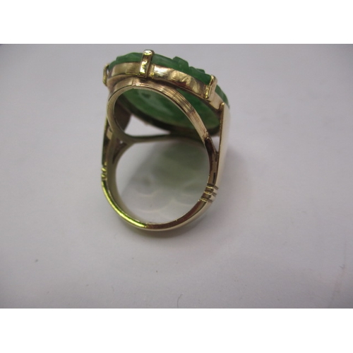 38 - A 9ct yellow gold ring with lotus blossom carved jade panel 20x30mm, approx. ring size ‘O’ approx. w... 