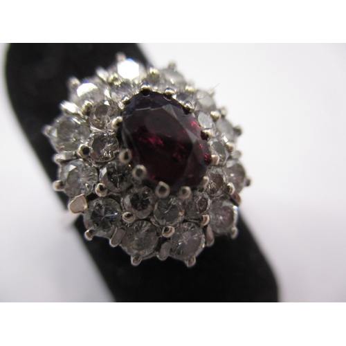 42 - An 18ct white gold diamond and ruby cluster ring, the ruby being a natural untreated stone, approx. ... 