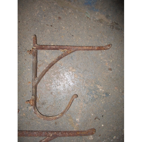 361 - A parcel of Victorian iron tack racks, to include a dog mask saddle rack which has boron fixing brok... 