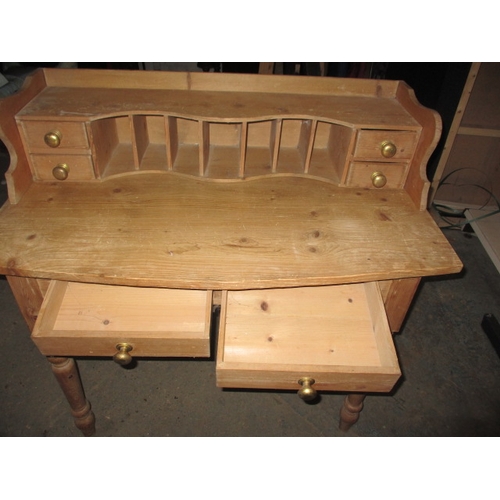 303 - An early 20th century waxed pine desk, with removable top rack, in good used condition