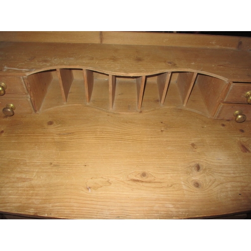 303 - An early 20th century waxed pine desk, with removable top rack, in good used condition