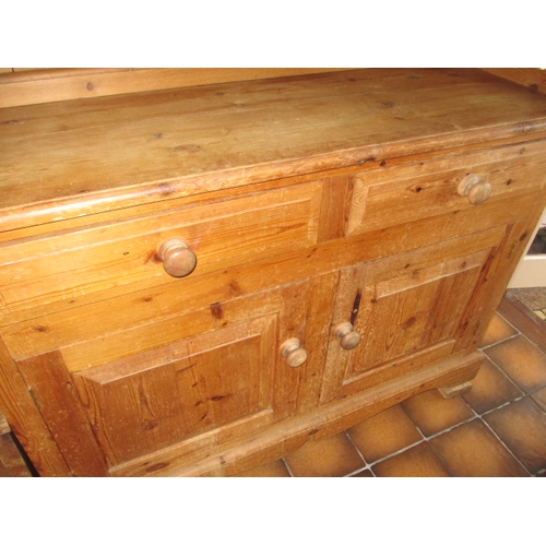 317 - A vintage natural pine kitchen dresser with glazed top rack with drawers and cupboards to base, in g... 