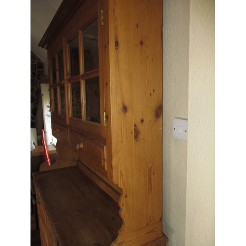 317 - A vintage natural pine kitchen dresser with glazed top rack with drawers and cupboards to base, in g... 